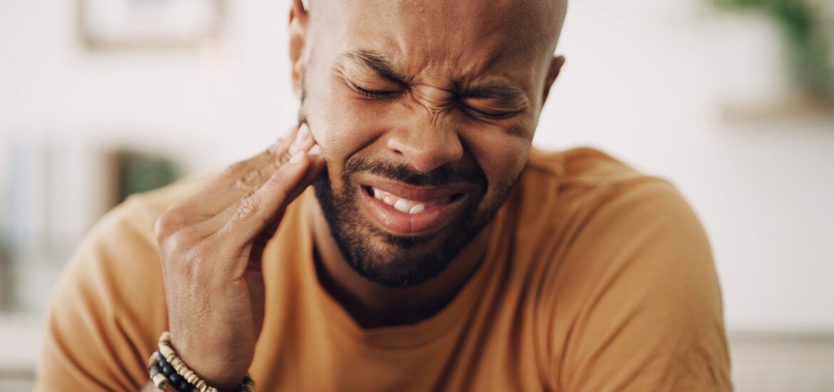 closeup of a man suffering a severe toothache, cracked tooth