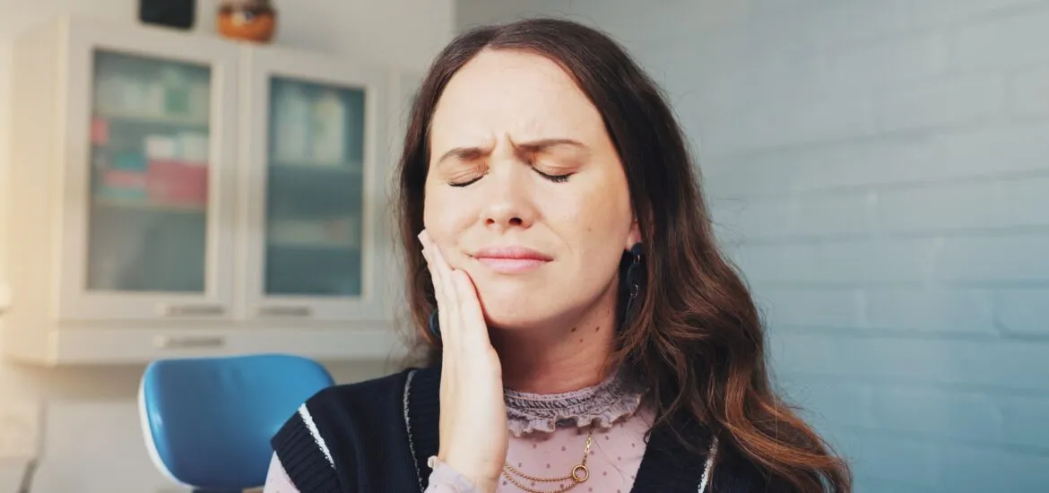 Cavity, pain and toothache with woman at dentist for appointment, checkup or extraction