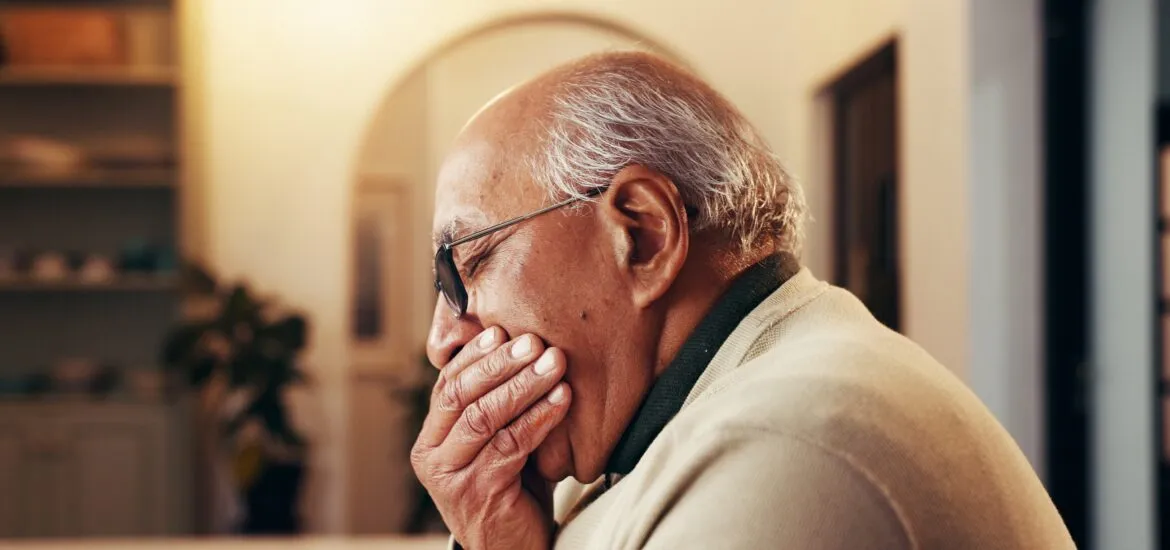 older man suffering from severe tooth oain, dental abscess